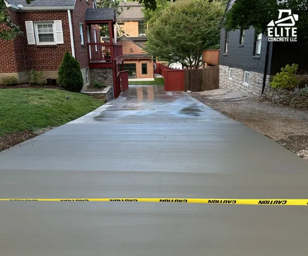 A ground-level view of a smooth, curved concrete driveway.