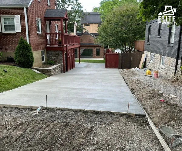 A ground-level view of a smooth, curved concrete driveway.
