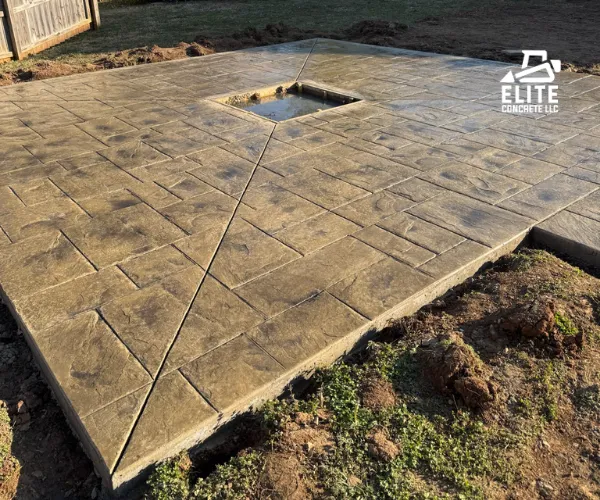 A large, square patio made of stamped concrete with a textured