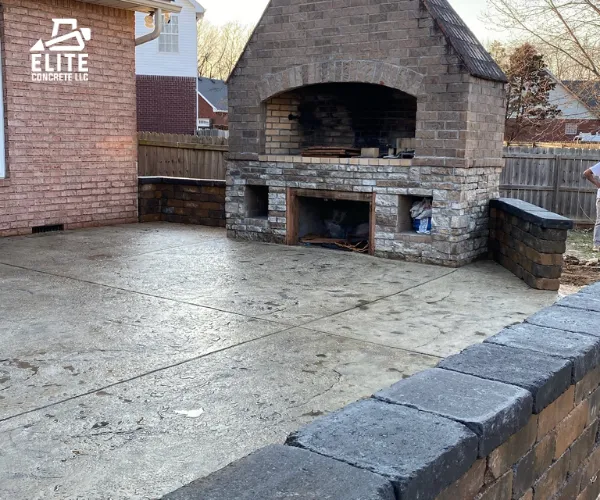 A completed outdoor living space featuring a smooth concrete patio